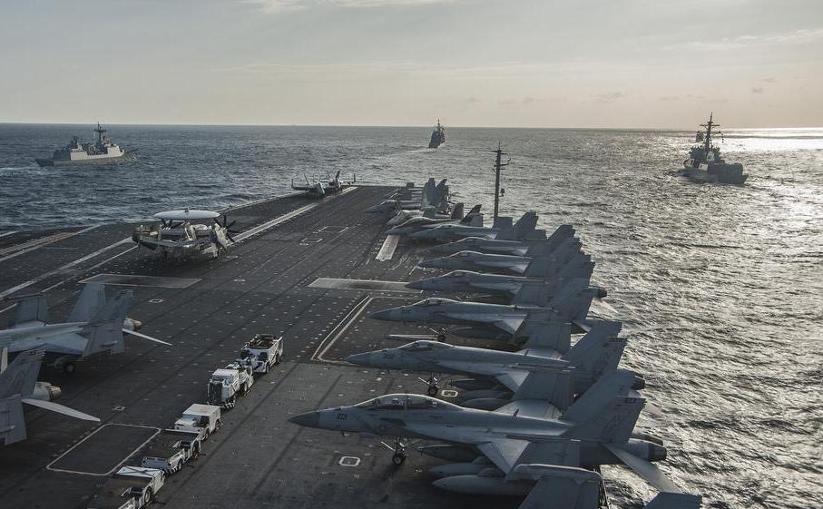 Hearing protection tactical headsets are used on the flight deck of an aircraft carrier to allow people to communicate without hearing damage.