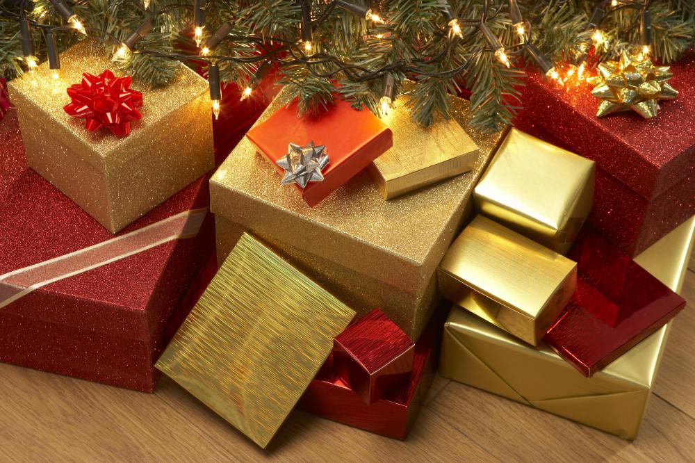 Christmas gifts under a tree with Christmas lights.