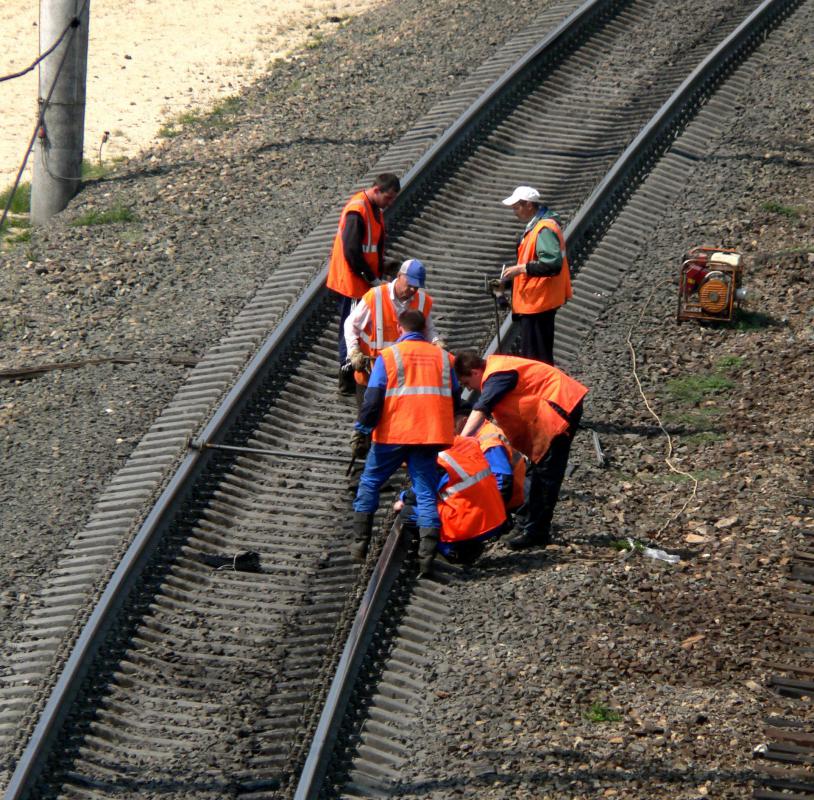 Railroad workers perform corrective maintenance on a track after a problem is uncovered.
