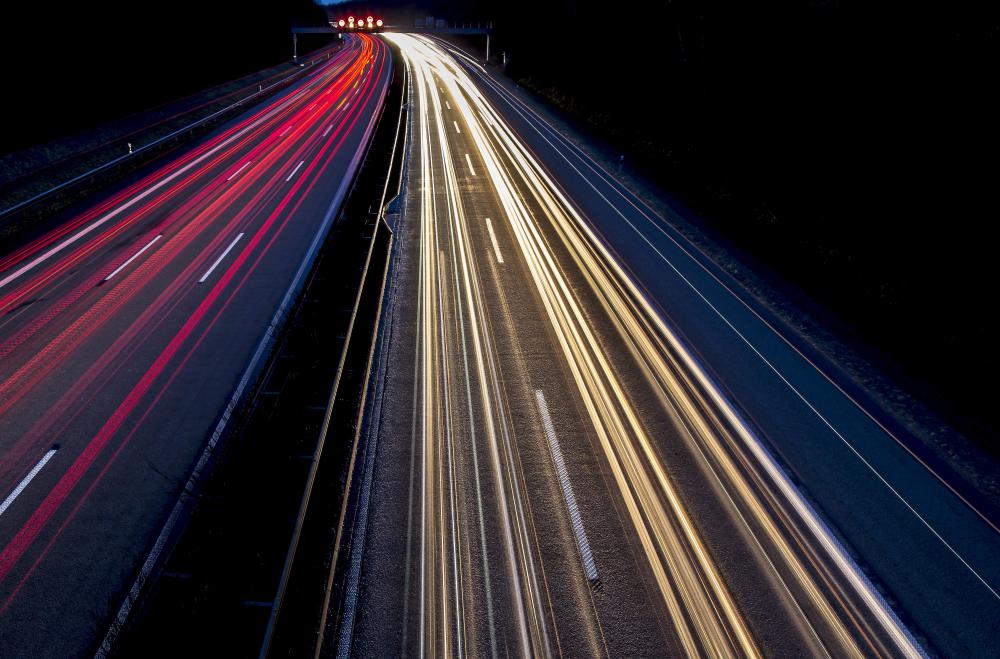 Filmmakers use time-lapse cameras to record actions over a period of time, such as car lights on a highway.