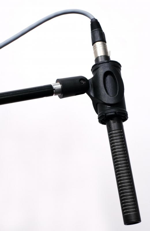 A boom microphone is mounted or attached to a pole or arm.