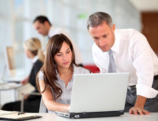 Two employees using lead manager software.