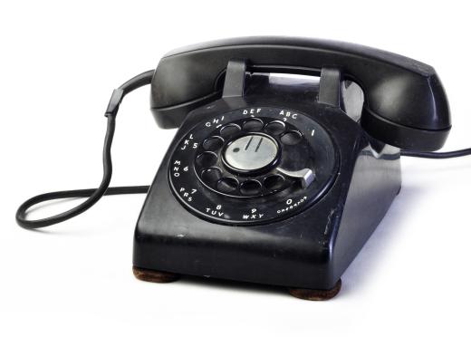 Classic black rotary dial telephone.