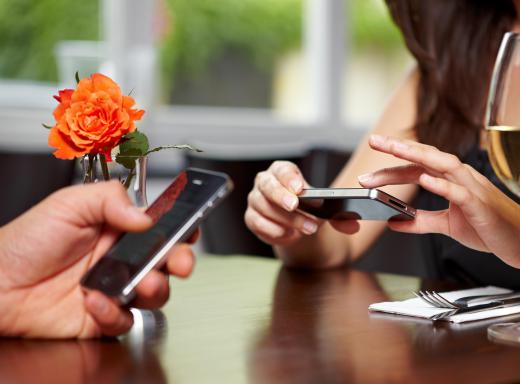 Two people using smartphones.