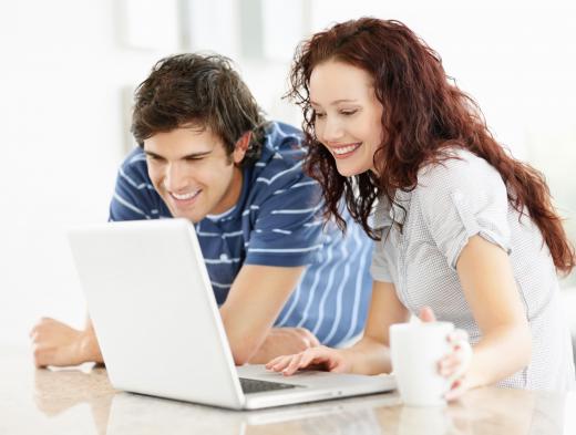 A couple using a laptop running on battery power.