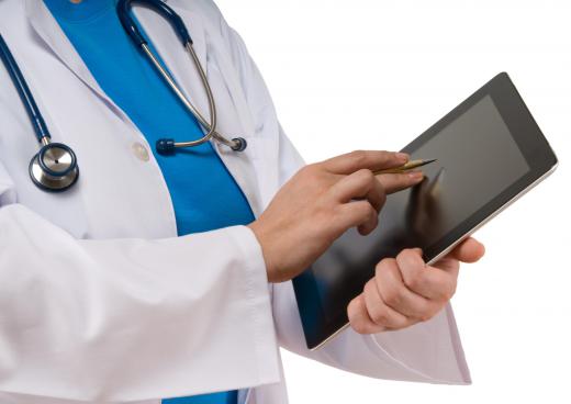 A doctor using a stylus on a tablet PC.