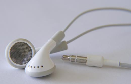 A close up of earbud headphones and headphone jack.