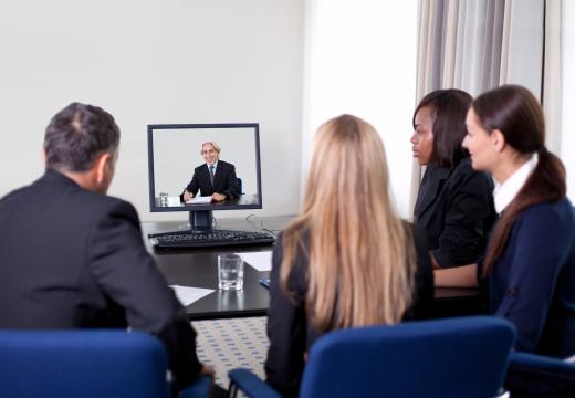 Group of businesspeople in a video conference, a type of Internet telecommunications technology.