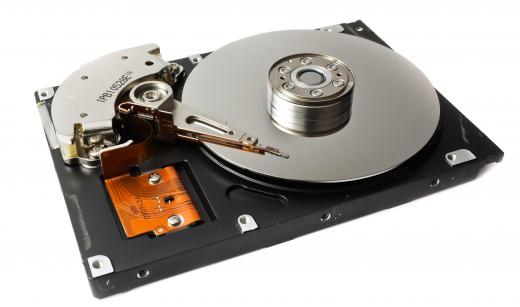 Hard disk with case removed to show the platters and the read-write head.