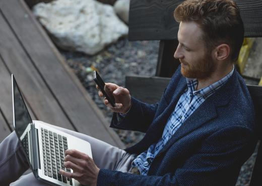 Mobile phones use wireless radio signals that communicate with signal towers to route voice information or data through the air.