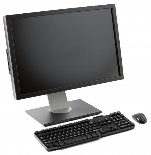 A desktop computer, keyboard, and mouse with a hidden tower.