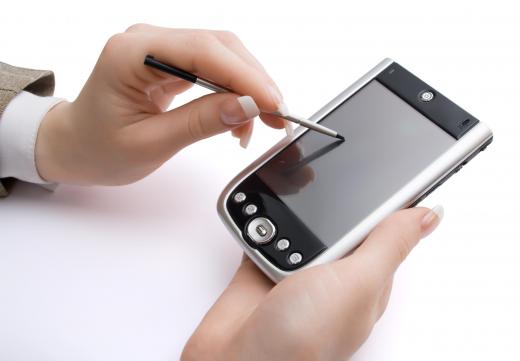 A person using a stylus with a PDA.